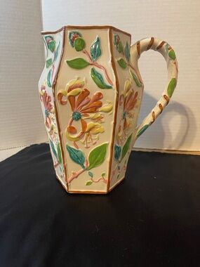 Cream Floral Relief Ceramic Pitcher with Green and Orange Accents